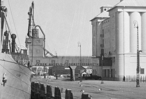 JAF havde også et siloanlæg på havnen i Esbjerg. På billedet ser man, hvordan der på den lange transportbro står skrevet "Jydsk Andels-Foderstofforretning" 